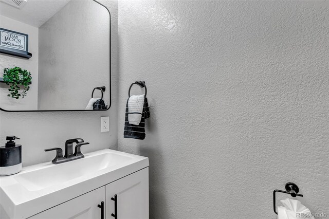 4013 S Carson St Unit C, Aurora, CO 80014 - bathroom with vanity and a textured wall