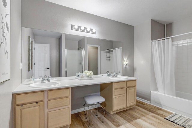 4013 S Carson St Unit C, Aurora, CO 80014 - full bath featuring double vanity, wood finished floors, and shower / bathtub combination with curtain