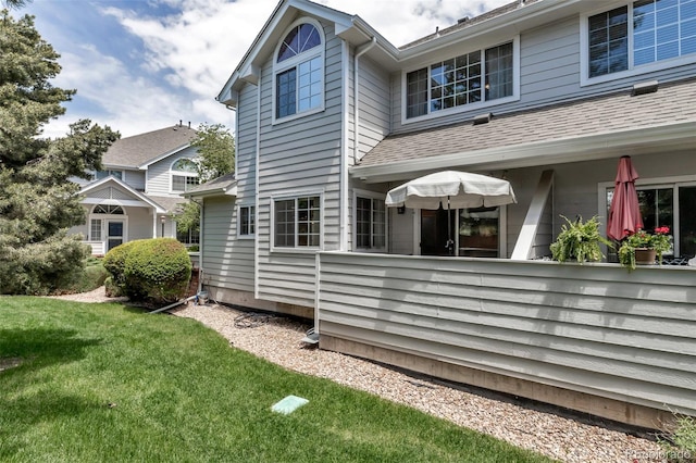 4013 S Carson St Unit C, Aurora, CO 80014 - view of side of property featuring a lawn and a shingled roof
