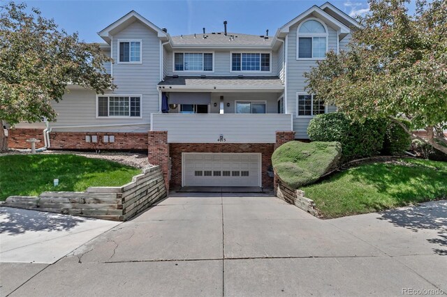 4013 S Carson St Unit C, Aurora, CO 80014 - view of front of house featuring a garage, driveway, and brick siding