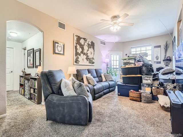 carpeted living room featuring ceiling fan