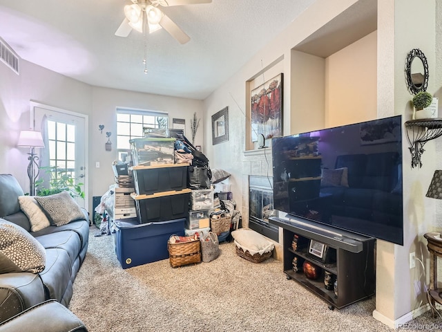 living room with carpet floors and ceiling fan