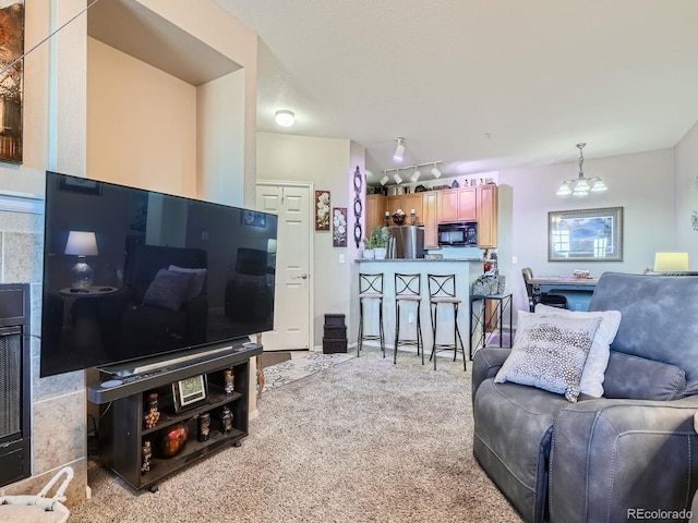 carpeted living room featuring a chandelier