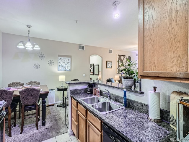 kitchen featuring sink, a notable chandelier, dark stone countertops, hanging light fixtures, and light tile patterned flooring