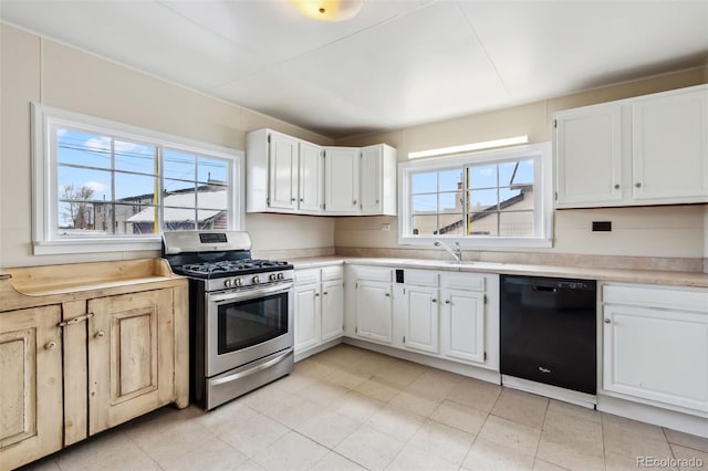 532 Front St, Fairplay, CO 80440 - kitchen with stainless steel range with gas stovetop, dishwasher, a sink, light countertops, and white cabinets