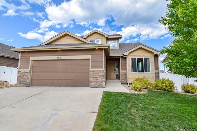 1057 Mt Oxford Ave, Severance, CO 80550 - view of front facade featuring concrete driveway, a garage, stone siding, and a shingled roof