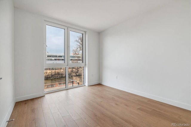 unfurnished room with light wood-type flooring