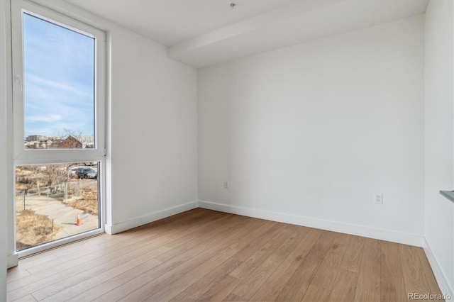 spare room featuring light hardwood / wood-style floors