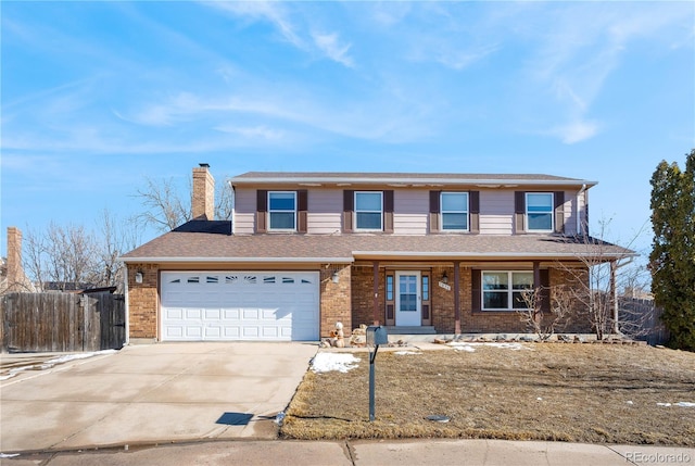 traditional home featuring a garage, concrete driveway, a chimney, fence, and brick siding