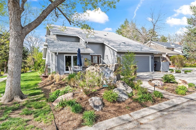 view of front of property featuring an attached garage, brick siding, and driveway