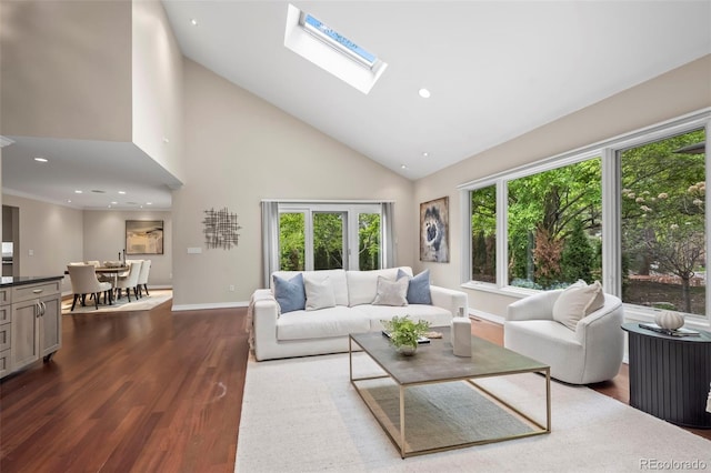 living area with a skylight, high vaulted ceiling, recessed lighting, dark wood-style flooring, and baseboards