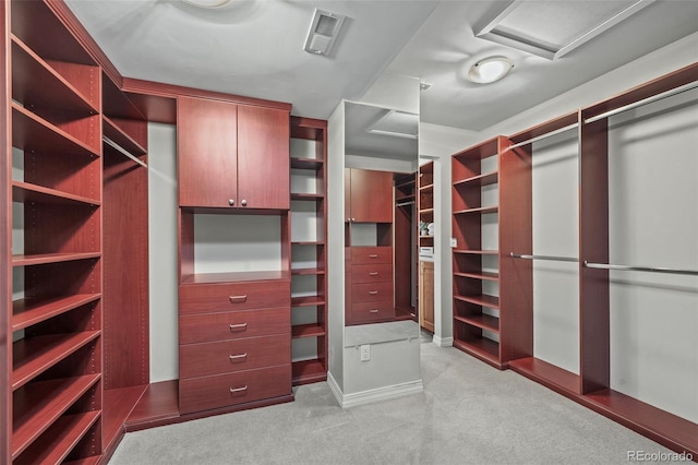 spacious closet featuring attic access, carpet floors, and visible vents