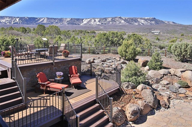 wooden deck with fence, stairs, and a mountain view