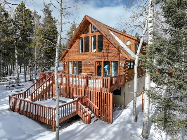 11498 Pauls Ln, Conifer, CO 80433 - snow covered house featuring stairway, a deck, and log exterior