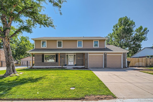 view of front of house featuring a porch, a front yard, and a garage