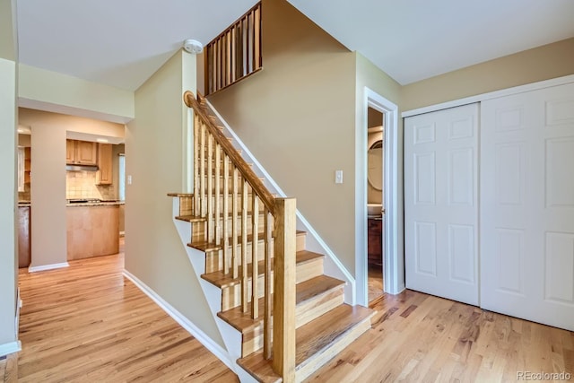 stairs featuring light hardwood / wood-style flooring