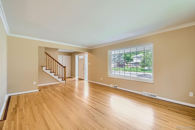 unfurnished room with light hardwood / wood-style flooring and ornamental molding