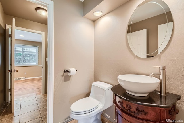 bathroom with vanity, hardwood / wood-style floors, and toilet