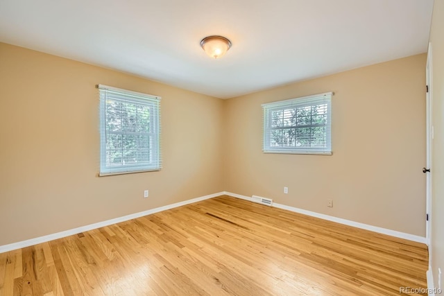 spare room featuring light wood-type flooring