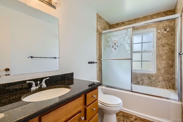 full bathroom with toilet, bath / shower combo with glass door, vanity, and tile patterned floors