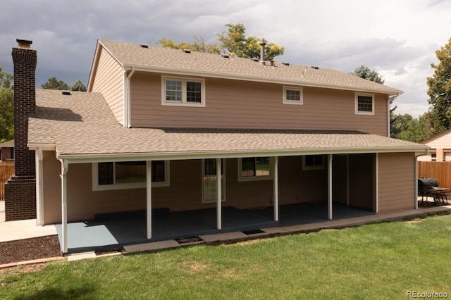 back of house with a lawn and a patio area