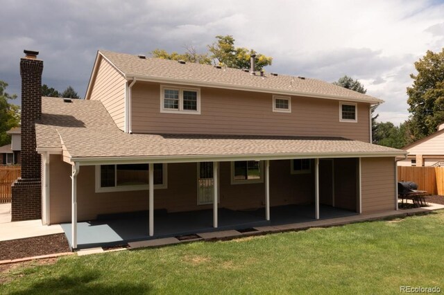 rear view of house featuring a patio area and a yard