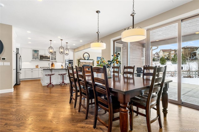 dining room featuring a fireplace and dark hardwood / wood-style floors