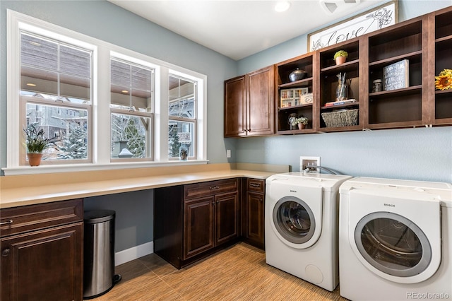 washroom with cabinets and separate washer and dryer