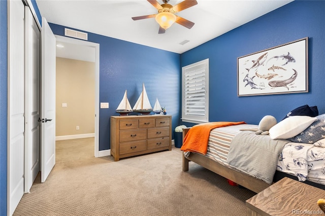 bedroom featuring light carpet, ceiling fan, and a closet