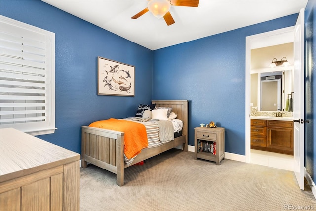 carpeted bedroom with sink, connected bathroom, and ceiling fan