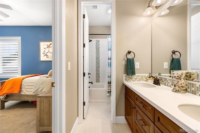 bathroom with tasteful backsplash, shower / tub combination, vanity, and ceiling fan