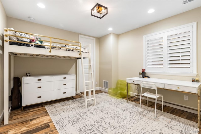 bedroom featuring dark hardwood / wood-style flooring