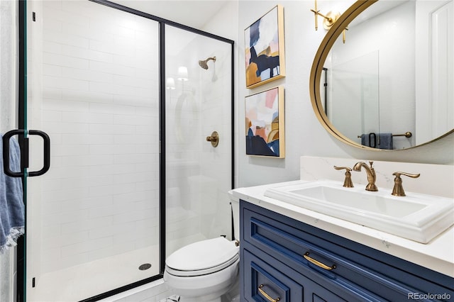 bathroom featuring vanity, toilet, and an enclosed shower