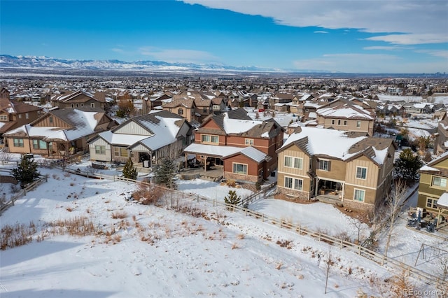 snowy aerial view featuring a mountain view