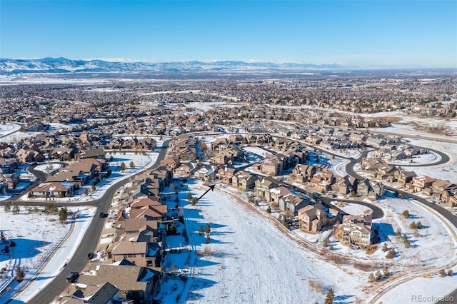 snowy aerial view featuring a mountain view