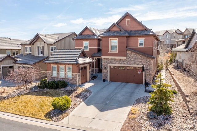 craftsman house with a garage, stone siding, a residential view, and driveway