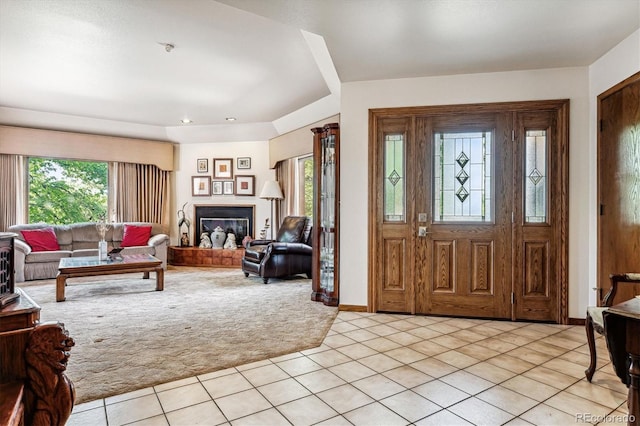 foyer featuring light carpet and plenty of natural light