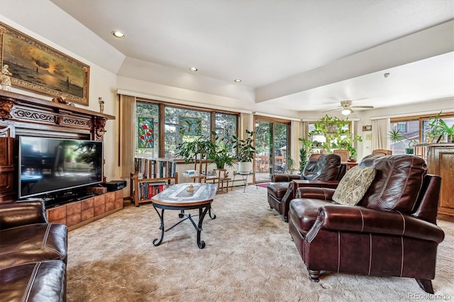 carpeted living room with plenty of natural light and ceiling fan