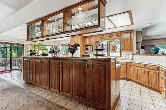 kitchen featuring light tile patterned floors, tasteful backsplash, and a kitchen island