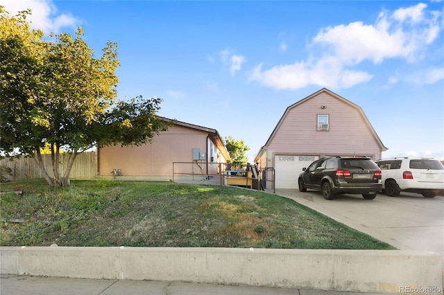 view of side of property featuring an outbuilding and a lawn