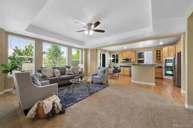 4821 Bluegate Dr, Highlands Ranch, CO 80130 - living room featuring a tray ceiling, plenty of natural light, ceiling fan, and recessed lighting