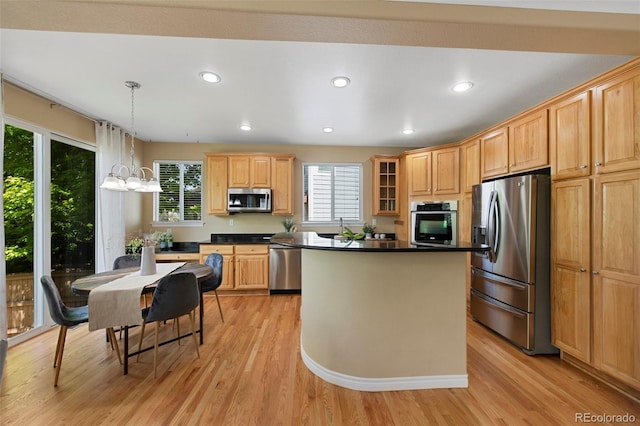 4821 Bluegate Dr, Highlands Ranch, CO 80130 - kitchen with stainless steel appliances, light wood finished floors, dark countertops, a kitchen island, and recessed lighting