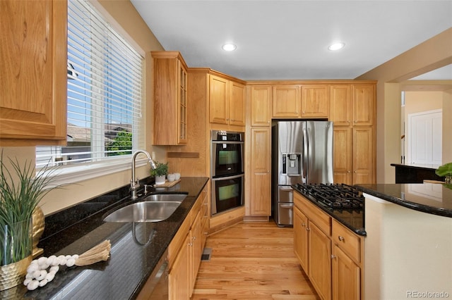 4821 Bluegate Dr, Highlands Ranch, CO 80130 - kitchen with a sink, appliances with stainless steel finishes, light wood-style flooring, dark stone counters, and recessed lighting