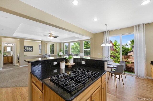 4821 Bluegate Dr, Highlands Ranch, CO 80130 - kitchen featuring a raised ceiling, black gas cooktop, baseboards, open floor plan, and recessed lighting