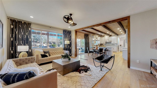 living room featuring beam ceiling, recessed lighting, baseboards, and light wood finished floors