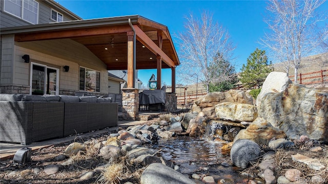 view of yard with outdoor lounge area and fence