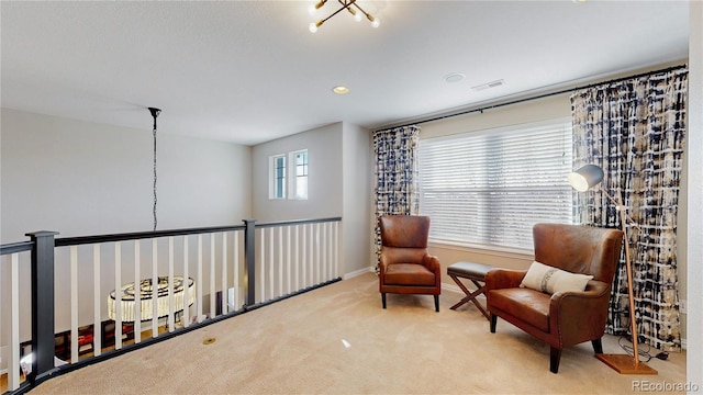 sitting room with baseboards, visible vents, and carpet floors