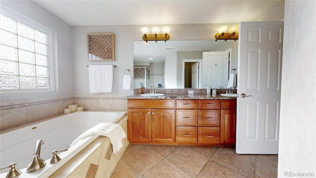 full bathroom with double vanity, a shower stall, a garden tub, and a sink