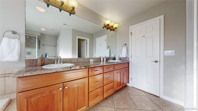 bathroom with visible vents, double vanity, a sink, tile patterned flooring, and a shower