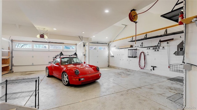 garage featuring recessed lighting and a garage door opener